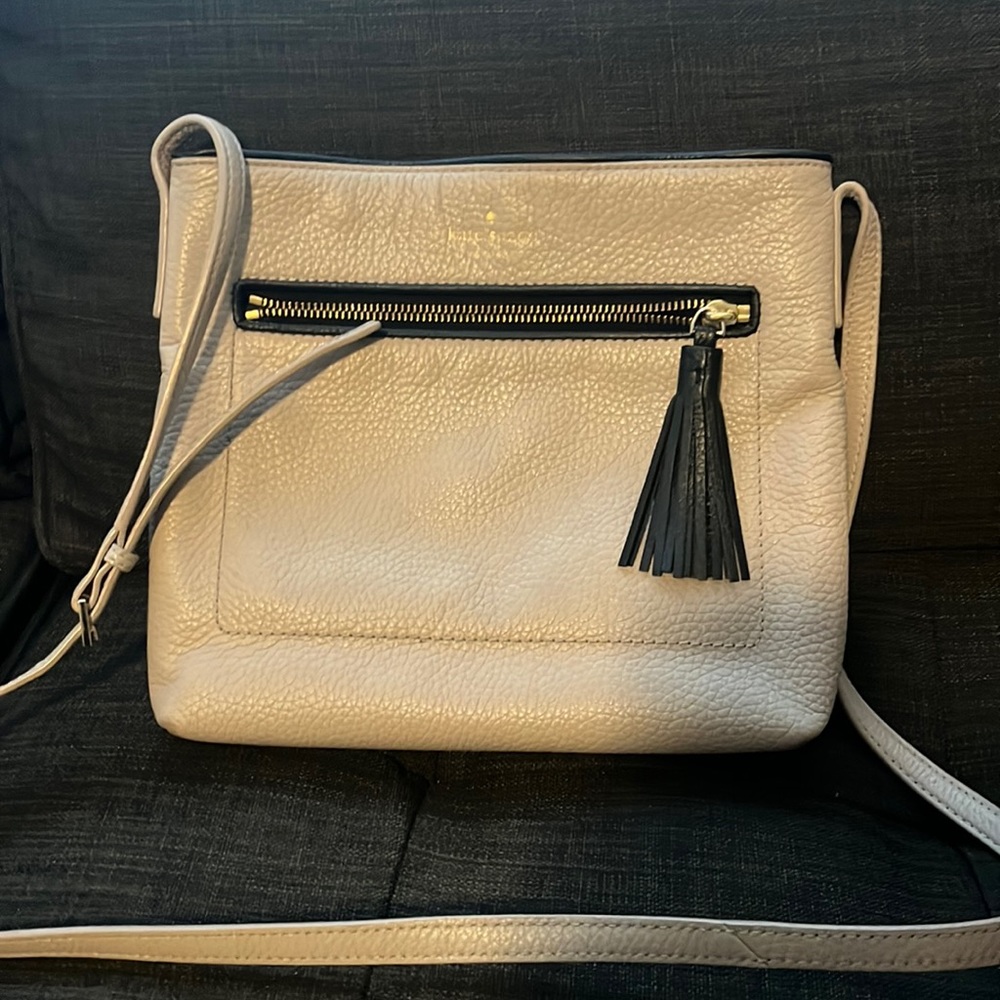 Kate spade crossbody bag with adjustable straps. Cream to tan in color.